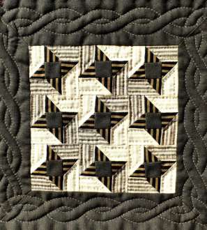 Quilted cable border around brown patchwork stars